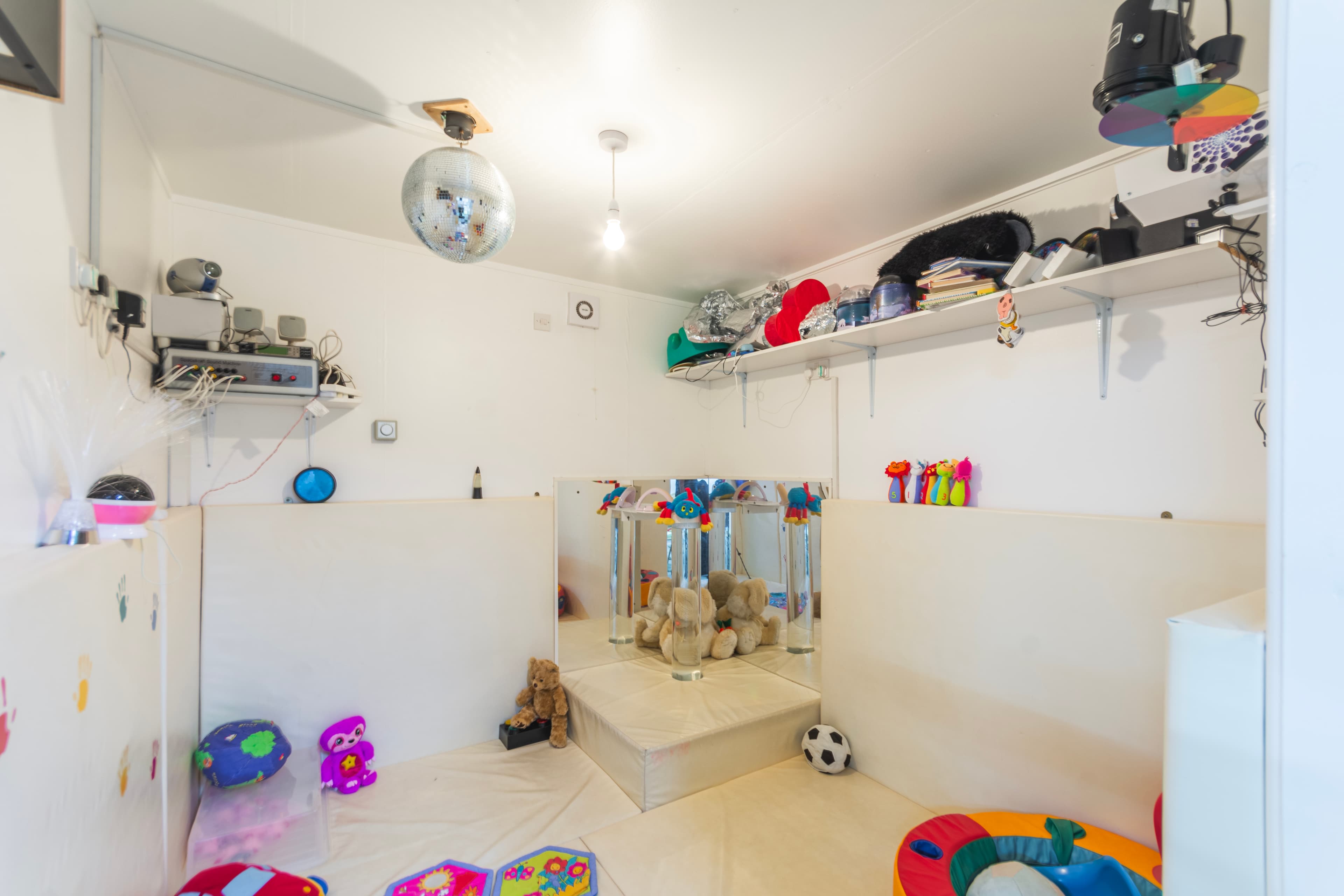 Sensory room with disco ball, mirrors and soft toys