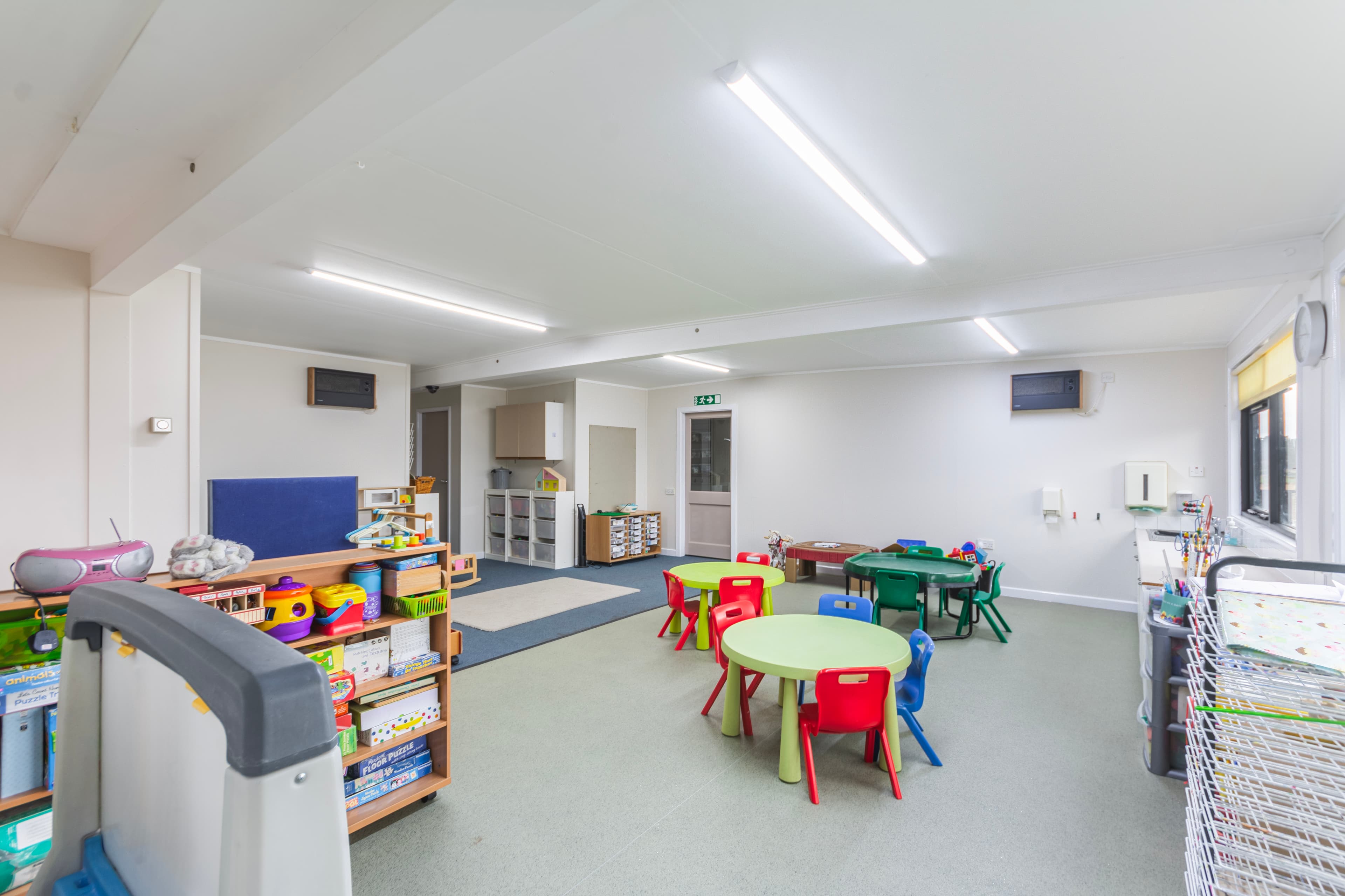 Toddler Room with tables, puzzles and activity areas