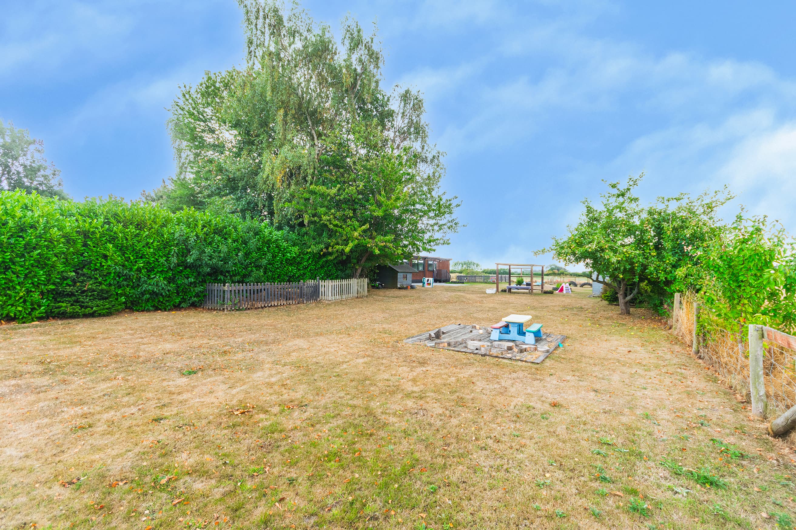 Garden area surrounded by hedgerows and trees