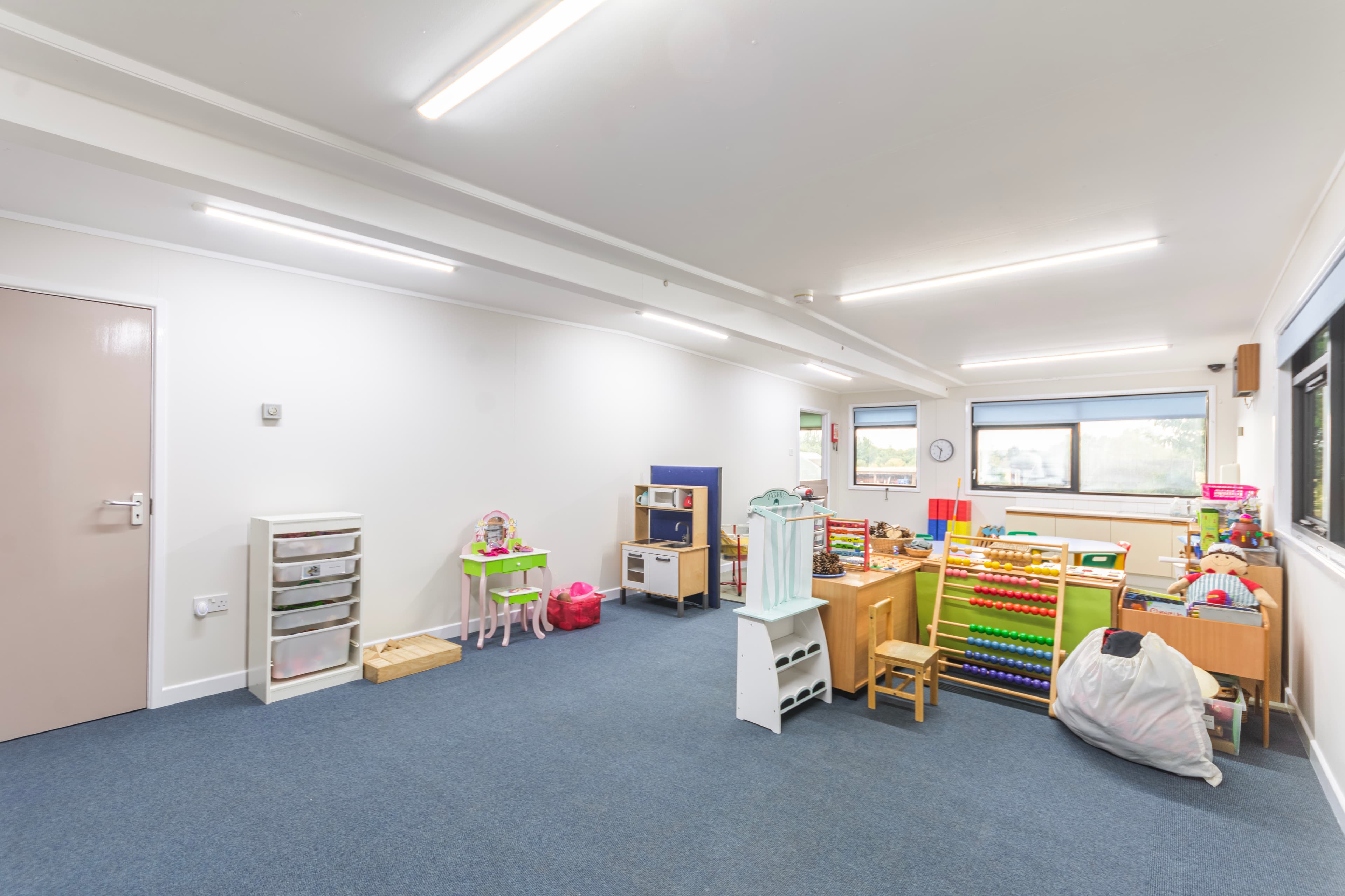 Pre-School Room with play kitchen, high chair and abacus